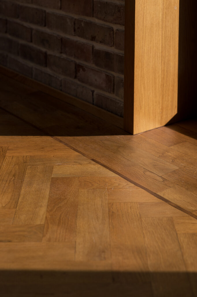 light-streaking-onto-wooden-herringbone-floor