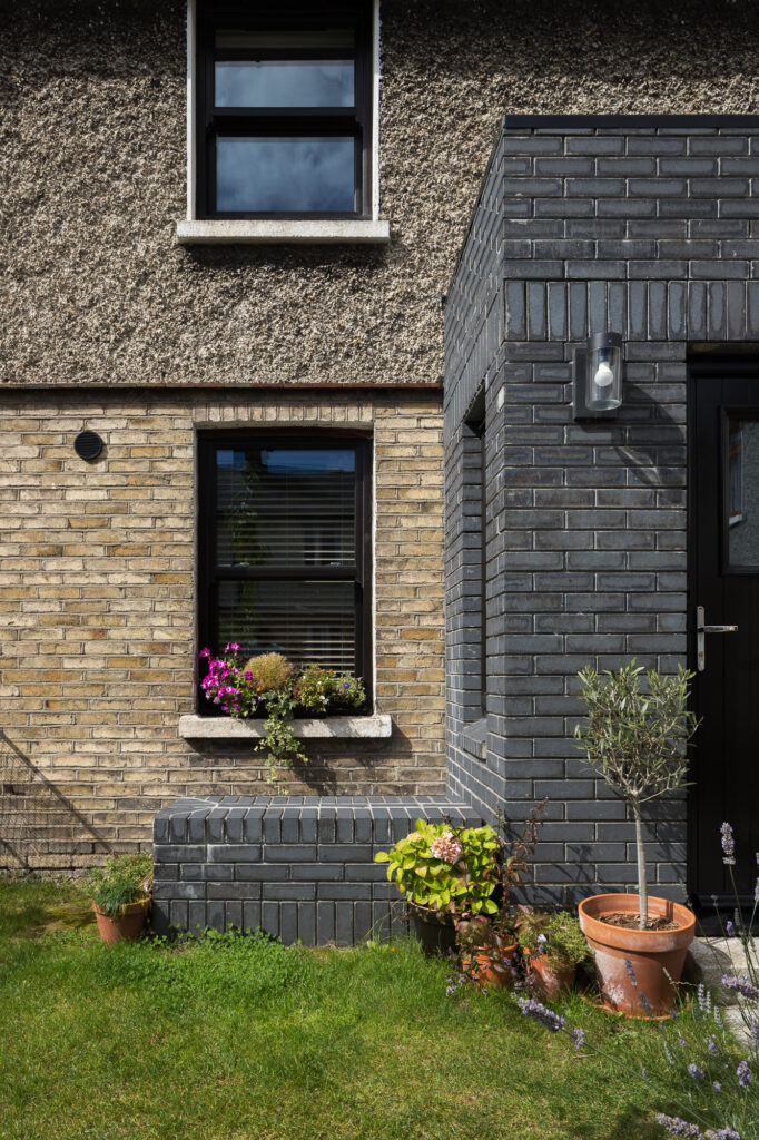 black-brick-porch-with-bench-and-brick-and-render-wall-of-house