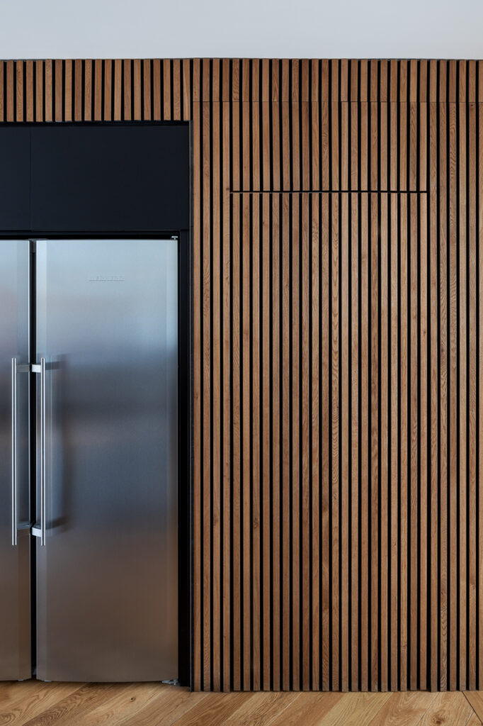 wooden-clad-door-from-kitchen-to-hidden-utility