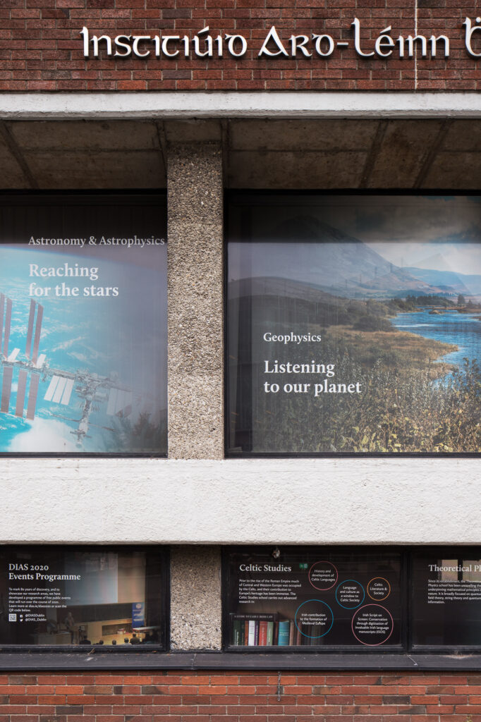 red-brick-modernist-building-of-school-of-theoretical-physics-with-exposed-aggregate-column-and-astronomy-and-geophysics-graphics-on-windows