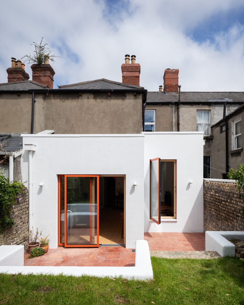 rear-elevation-with-orange-framed-windows-and-white-walls-extended-from-terraced-house