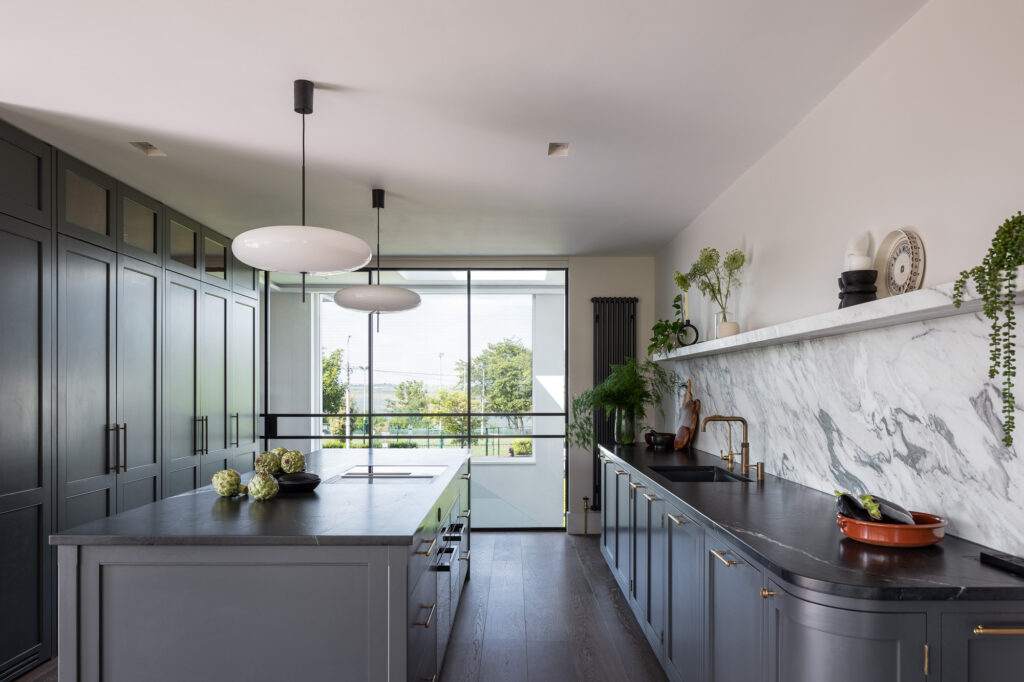 interior-dark-blue-kitchen-with-marble-black-top-with-view-to-malahide
