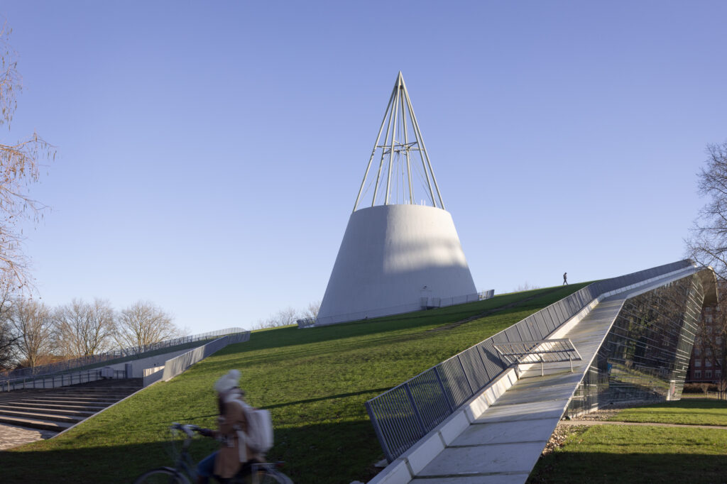 TU-Delft-Library-with-man-walking-along-ridge-and-cyclist-passing-by