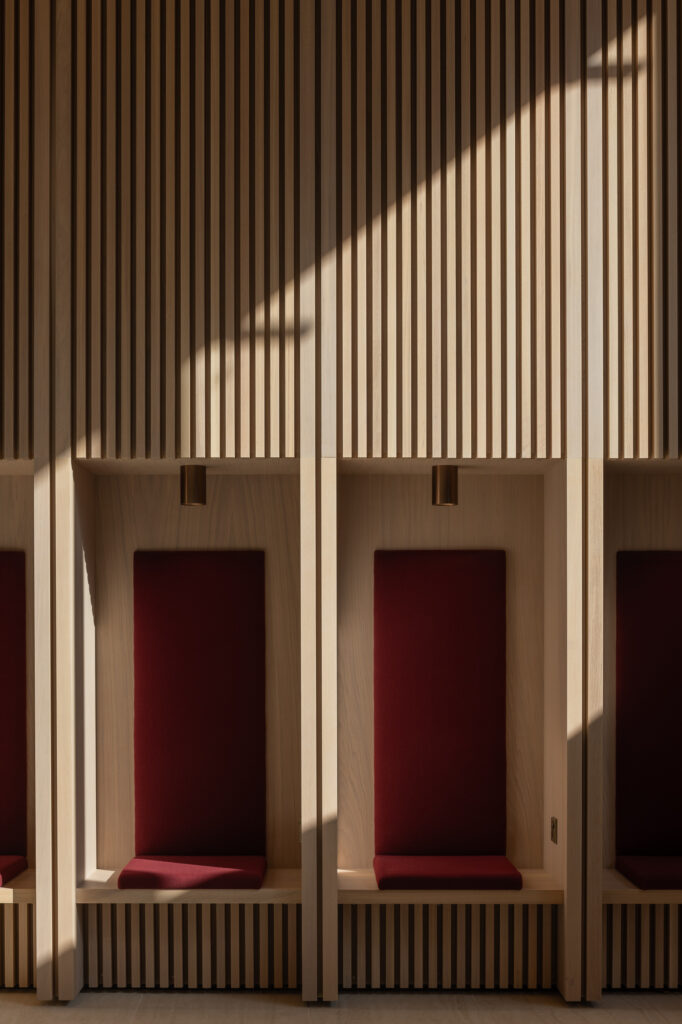 wooden-built-in-seating-with-red-cushions-in-alcoves