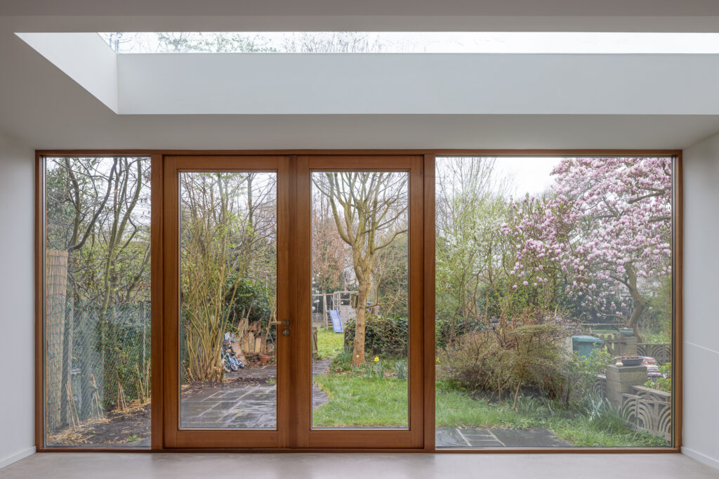 floor-to-ceiling-wooden-framed-windows-and-doors-to-garden
