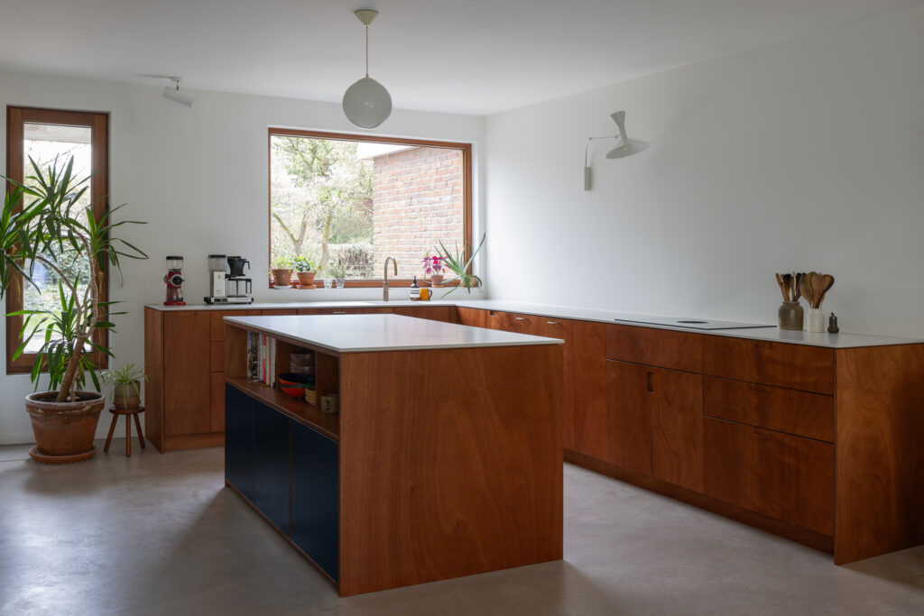 dark-wood-and white-counter-top-kitchen-with-wooden-window-framed-windows