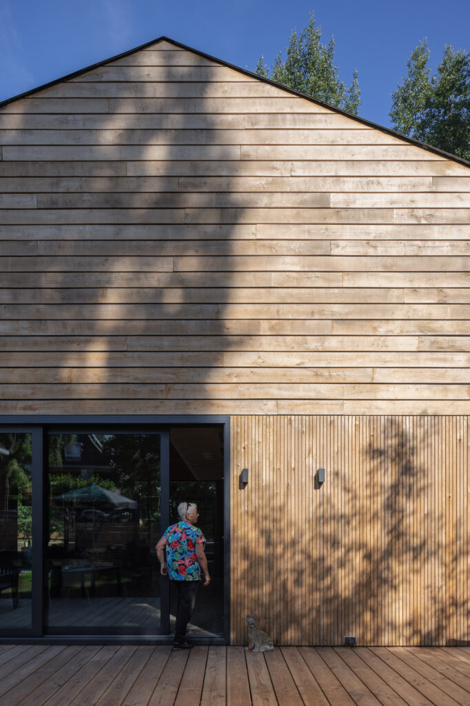 wooden-clad-Barn-House-in-sun-and-shadows-from-trees