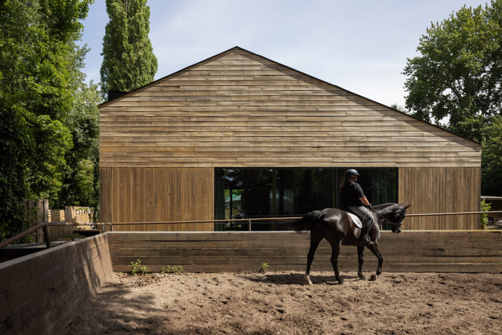 Wooden-Clad-House-with-black-horse-in-front-Ard-Buijsen-Barn-House-Andrew-Campion-Photography