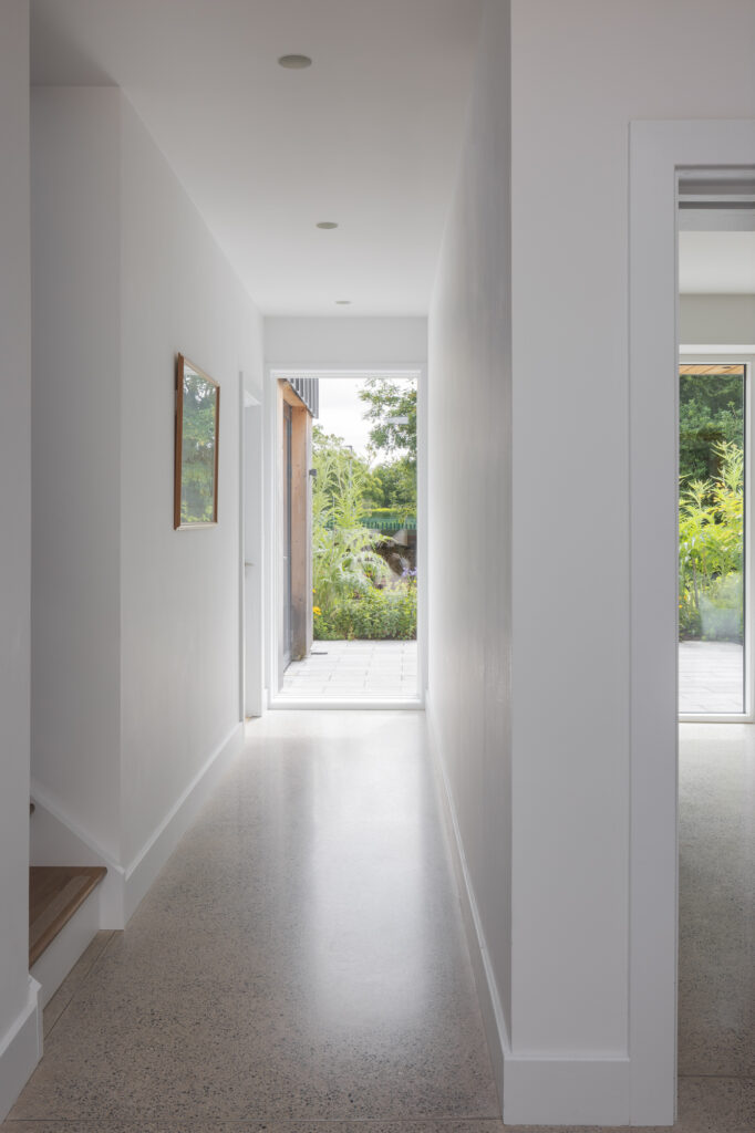 white-walled-hallway-with-view-to-garden