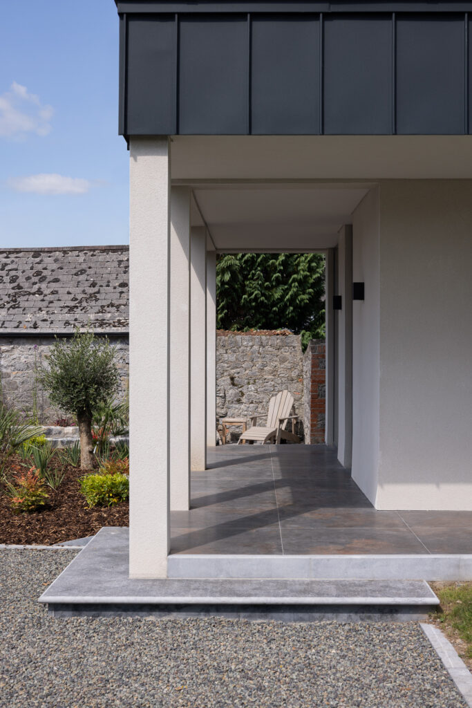 colonnade-with-zinc-capping-to-walled-garden-with-wooden-lounger