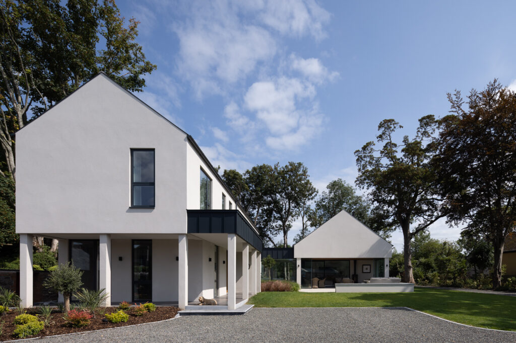 two-storey-pitched-roof-l-shaped-modern-residence-surrounded-by-mature-trees