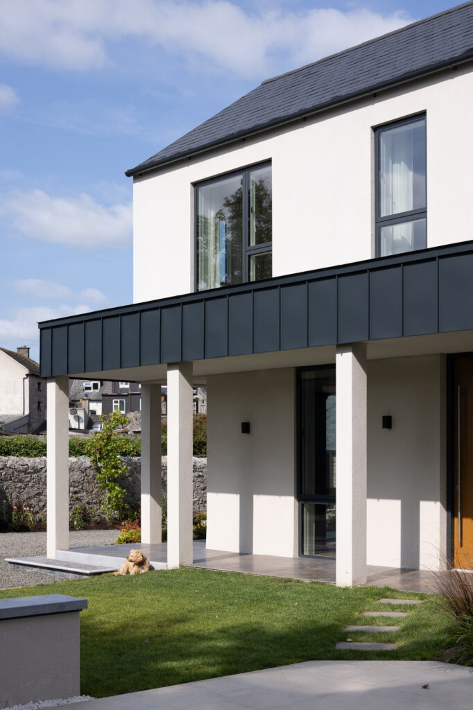 two-storey-pitched-roof-shaped-modern-house-with-zinc-topped-colonnade